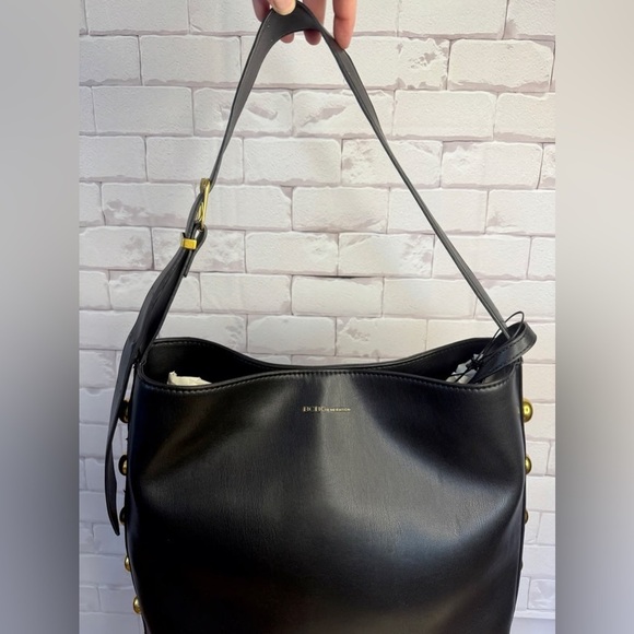 BCBGMaxAzria Handbags - BCBGMaxAzria Black and Gold Shoulder Bag with Elegant Design